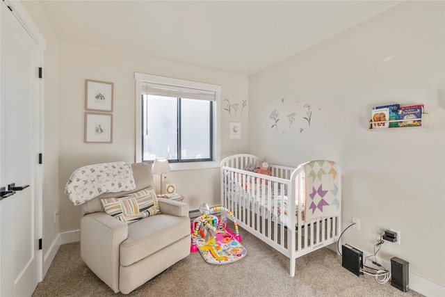 bedroom with a crib and carpet floors