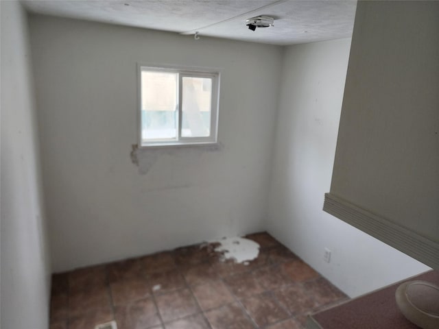 spare room with a textured ceiling