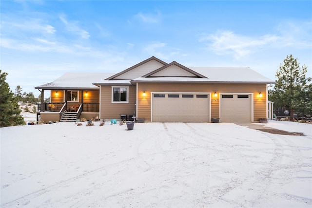 view of front of home with covered porch and a garage