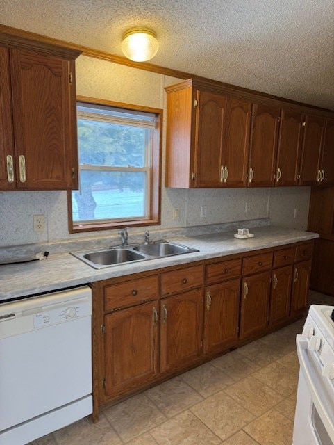 kitchen featuring a textured ceiling, decorative backsplash, sink, and white appliances