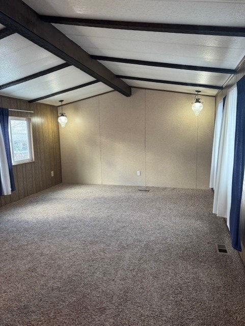 unfurnished room featuring carpet flooring, vaulted ceiling with beams, and wooden walls