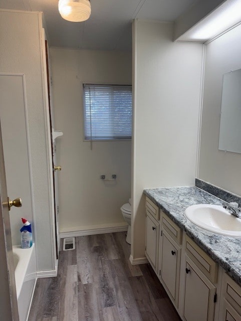 bathroom featuring hardwood / wood-style floors, vanity, and toilet