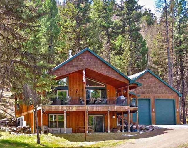 view of front facade featuring a garage and a balcony