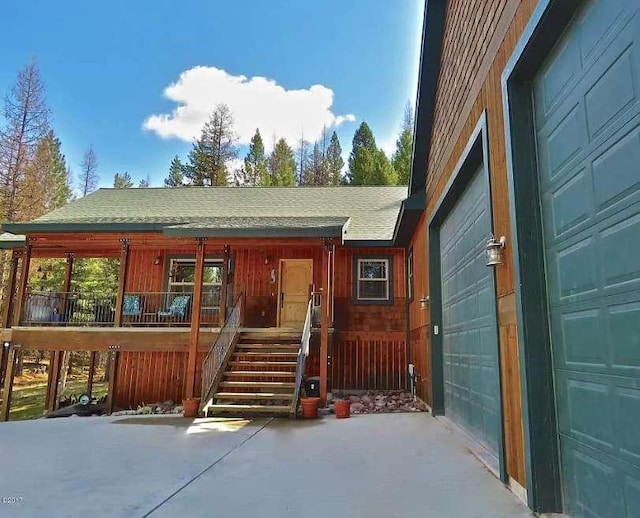 view of exterior entry featuring covered porch