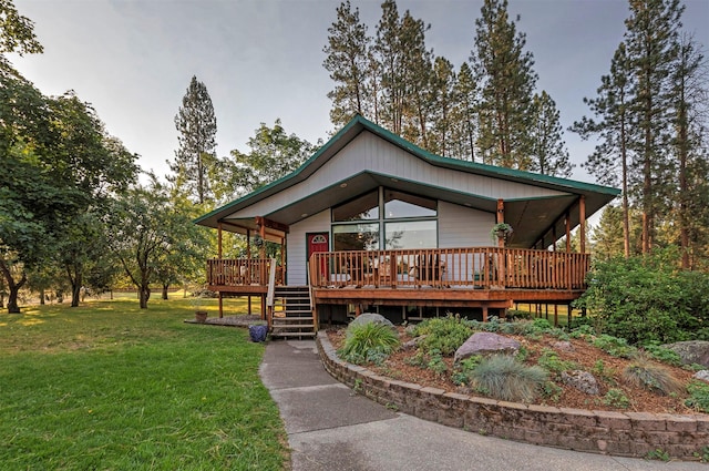 view of front of house featuring a front lawn and a deck