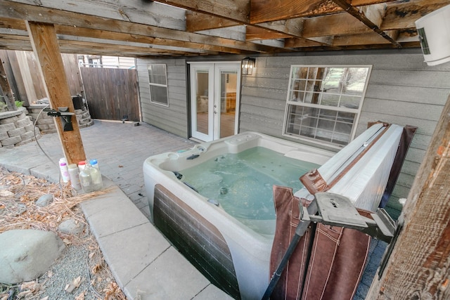 view of patio / terrace featuring a hot tub and french doors