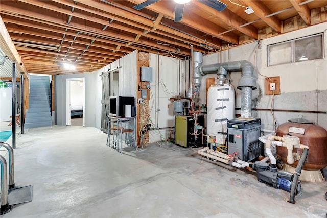 basement with ceiling fan and water heater