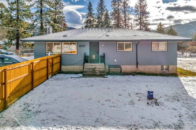 snow covered property featuring a mountain view