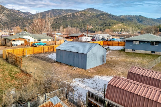 exterior space with a mountain view and an outbuilding