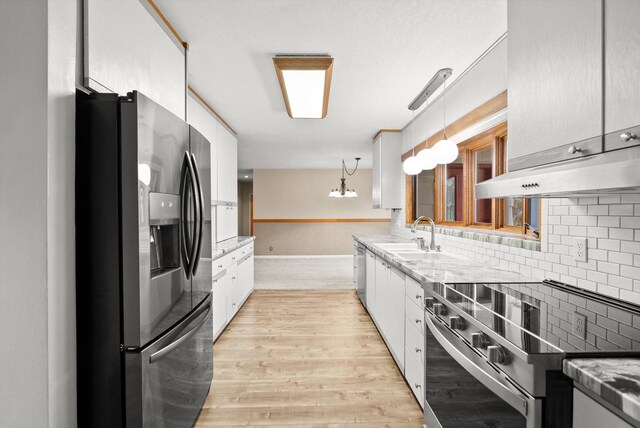 444 S Meridian Rd, Kalispell, MT 59901 - kitchen featuring stainless steel appliances, a sink, decorative backsplash, and white cabinetry