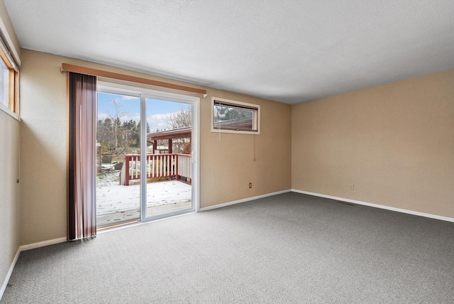 unfurnished room with carpet and baseboards