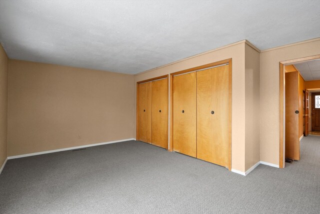 444 S Meridian Rd, Kalispell, MT 59901 - unfurnished bedroom with baseboards, carpet, and multiple closets