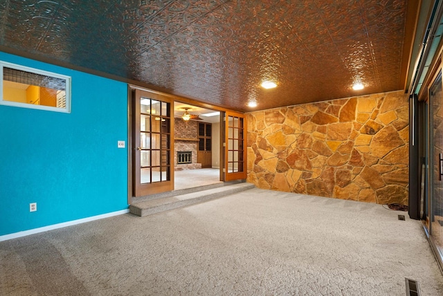 444 S Meridian Rd, Kalispell, MT 59901 - empty room featuring an ornate ceiling, a fireplace, carpet floors, a ceiling fan, and baseboards
