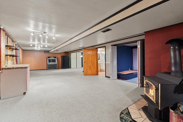 444 S Meridian Rd, Kalispell, MT 59901 - finished below grade area featuring a wood stove and a textured ceiling