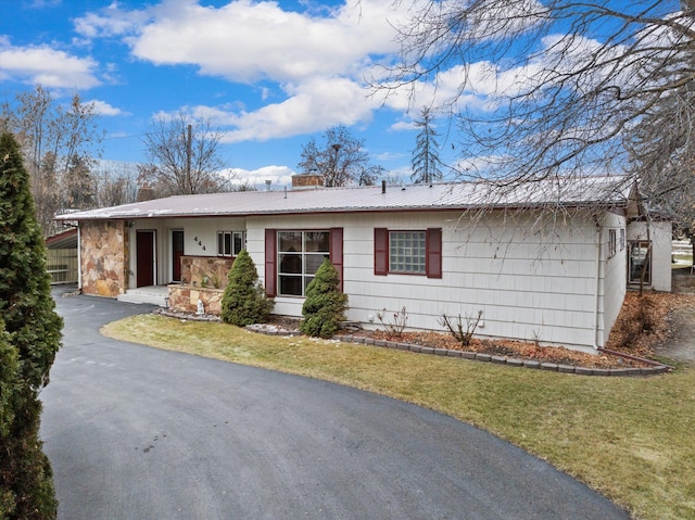 444 S Meridian Rd, Kalispell, MT 59901 - ranch-style home with asphalt driveway, a front lawn, and metal roof