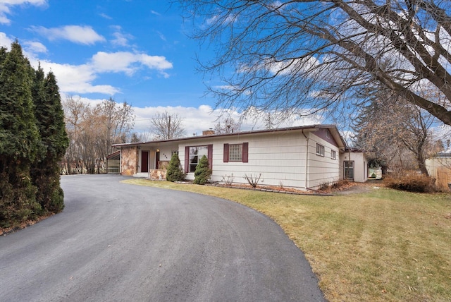 444 S Meridian Rd, Kalispell, MT 59901 - ranch-style house with a front lawn, a chimney, and driveway
