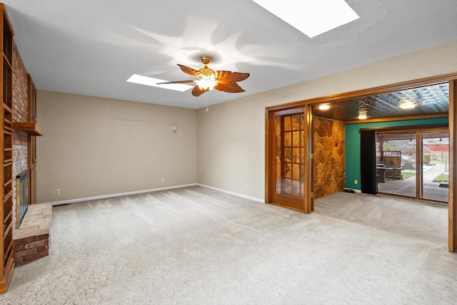 444 S Meridian Rd, Kalispell, MT 59901 - unfurnished living room with a skylight, carpet flooring, ceiling fan, and a brick fireplace