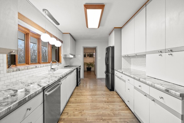 444 S Meridian Rd, Kalispell, MT 59901 - kitchen with stainless steel appliances, a sink, tasteful backsplash, and light wood finished floors