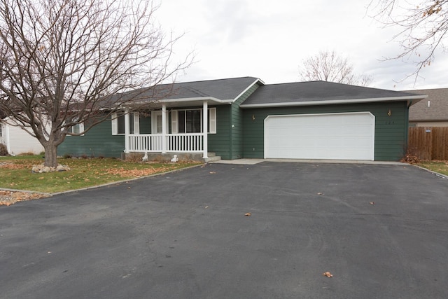 ranch-style house featuring a porch and a garage