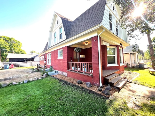 view of property exterior with a lawn and a porch