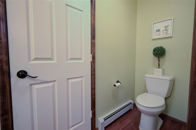 bathroom featuring wood-type flooring, toilet, and baseboard heating