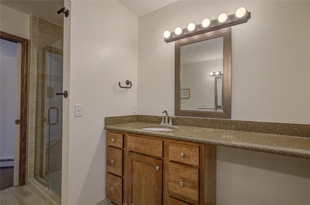 bathroom with vanity, baseboard heating, and walk in shower