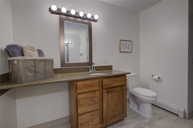 bathroom featuring baseboard heating, vanity, and toilet