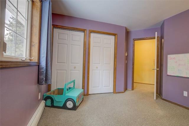 unfurnished bedroom with light carpet and two closets