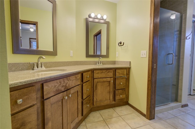 bathroom with tile patterned flooring, vanity, and a shower with door