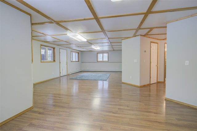 unfurnished room with coffered ceiling and light hardwood / wood-style flooring