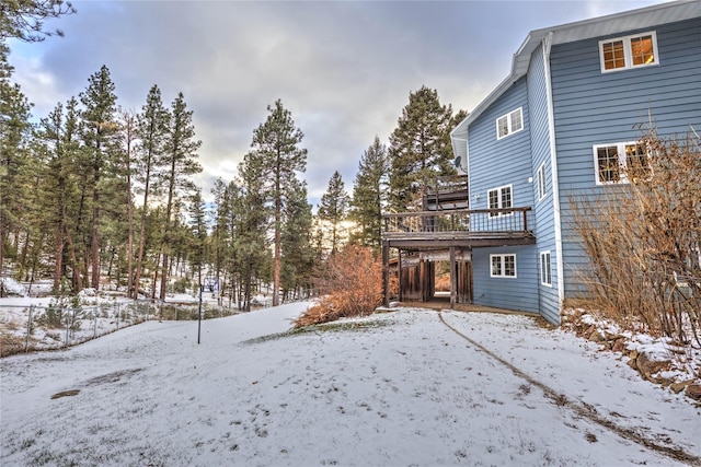 snowy yard with a wooden deck