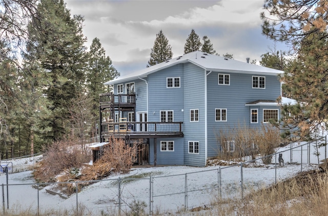 snow covered property featuring a wooden deck