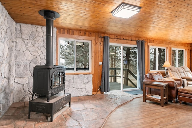 421 Tie Chute Ln, Florence, MT 59833 - living room featuring a wood stove, wooden walls, wood ceiling, and lofted ceiling