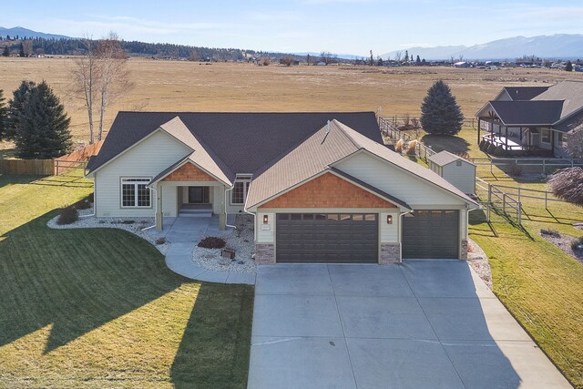 view of front of property featuring a front yard and a garage