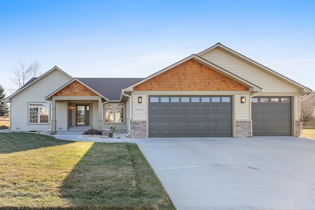 craftsman house with concrete driveway, an attached garage, and a front lawn