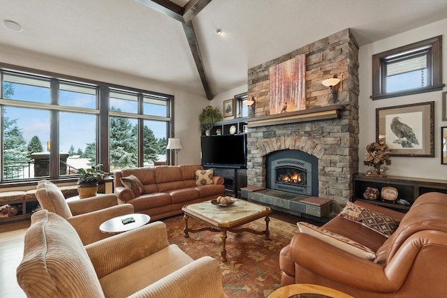 living room with a fireplace, lofted ceiling with beams, and a wealth of natural light