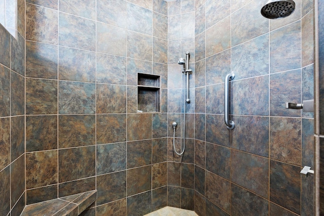 bathroom with tiled shower