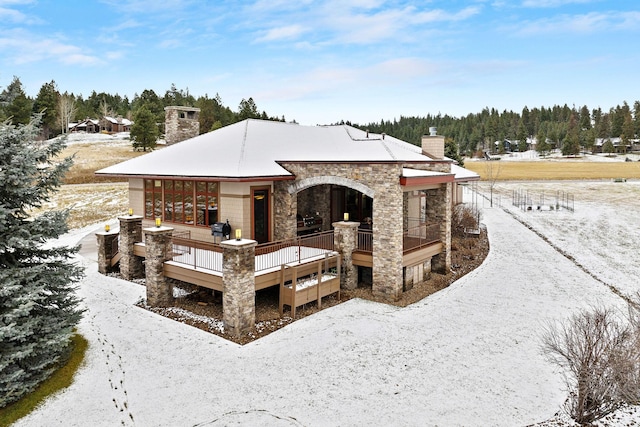 view of snow covered rear of property