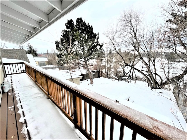 view of snow covered back of property