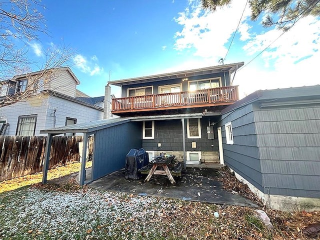 rear view of house featuring a balcony