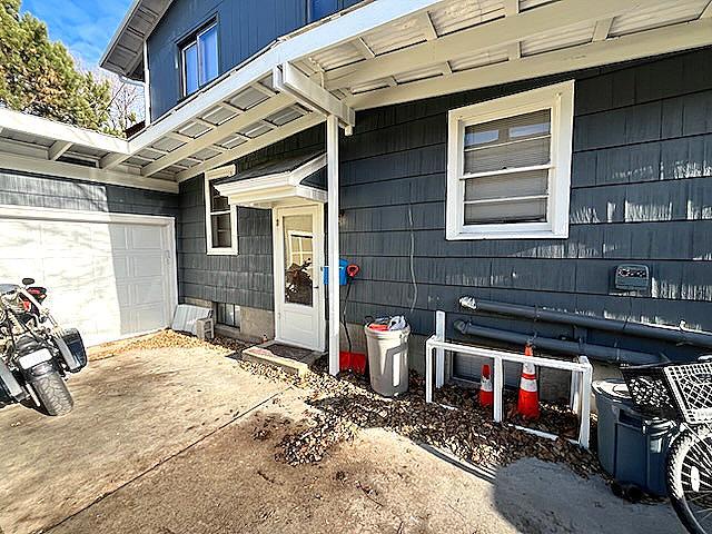 view of exterior entry with a garage