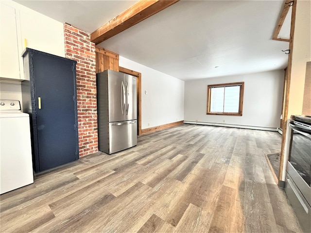 kitchen featuring light wood-type flooring, a baseboard radiator, beamed ceiling, washer / dryer, and stainless steel appliances