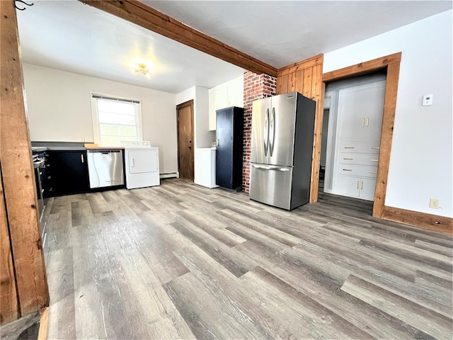 kitchen featuring washer / clothes dryer, light wood-type flooring, and appliances with stainless steel finishes