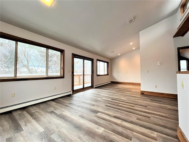 unfurnished living room featuring light wood-type flooring, lofted ceiling, and a baseboard heating unit