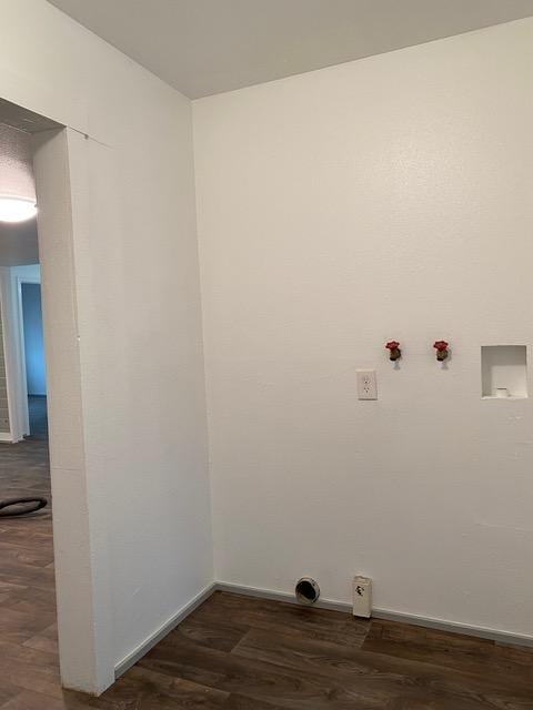 clothes washing area featuring washer hookup and dark wood-type flooring