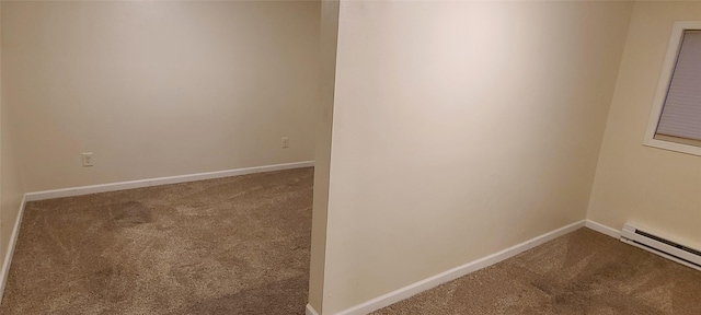 unfurnished room featuring carpet flooring and a baseboard heating unit