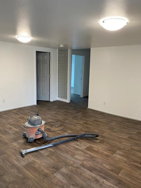 spare room with dark hardwood / wood-style flooring and a textured ceiling