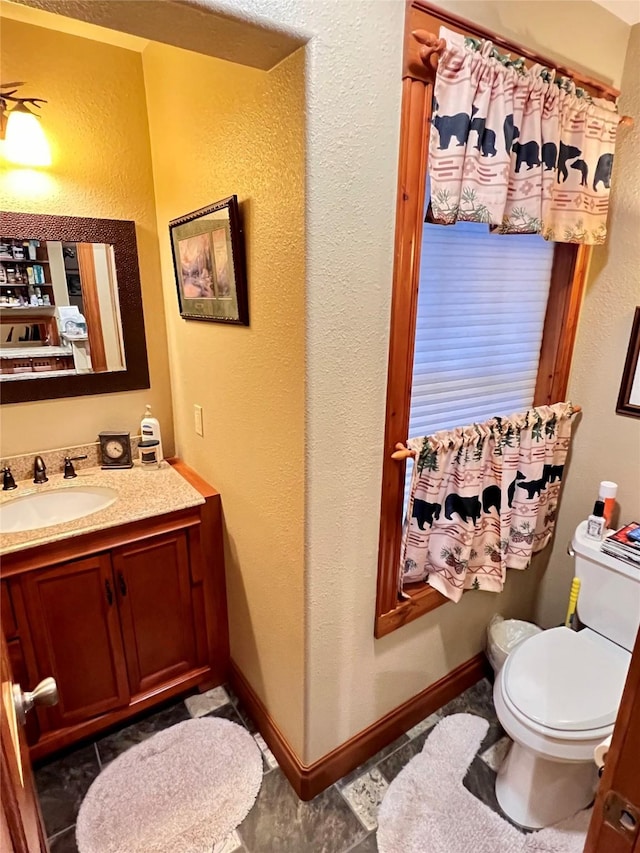 bathroom featuring tile patterned flooring, vanity, and toilet