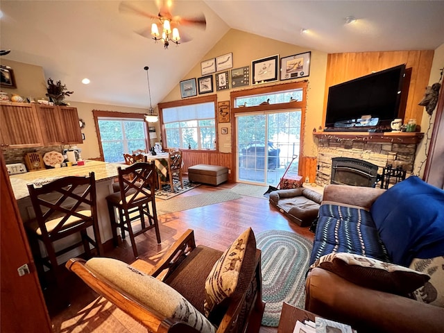 living room with ceiling fan, light hardwood / wood-style floors, a fireplace, and a wealth of natural light