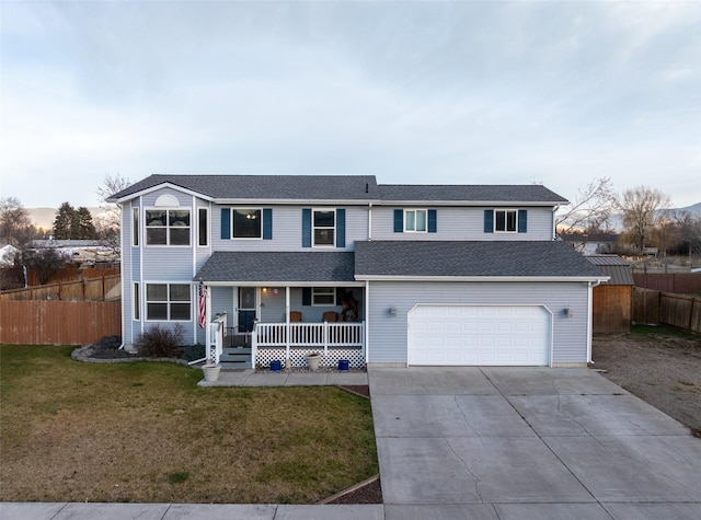 view of front property featuring a front yard, a porch, and a garage